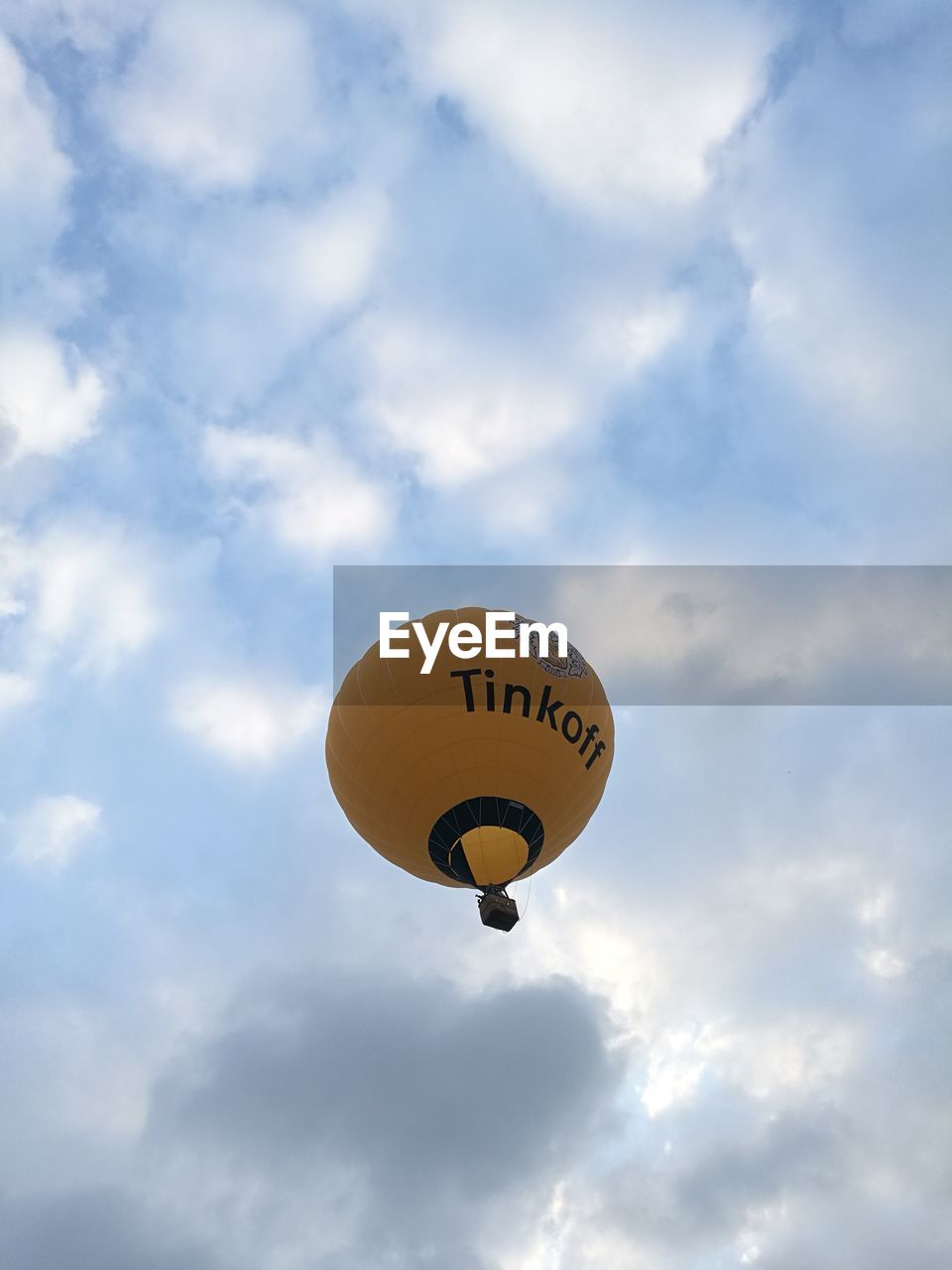 LOW ANGLE VIEW OF YELLOW BALLOONS FLYING AGAINST SKY