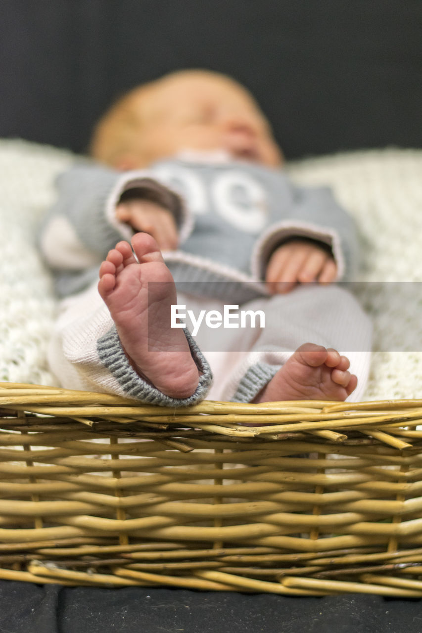 Newborn baby resting in wicker basket