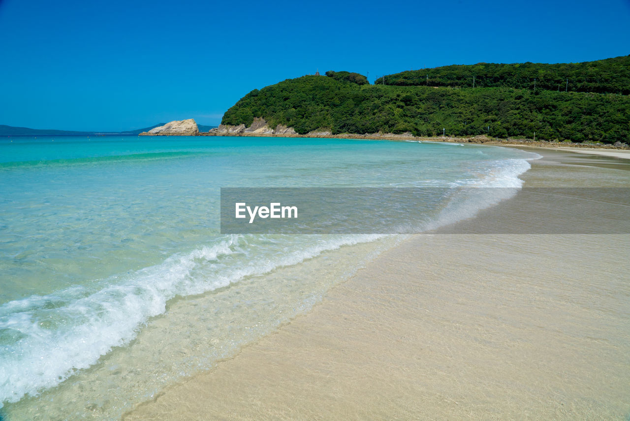 Scenic view of sea against clear blue sky