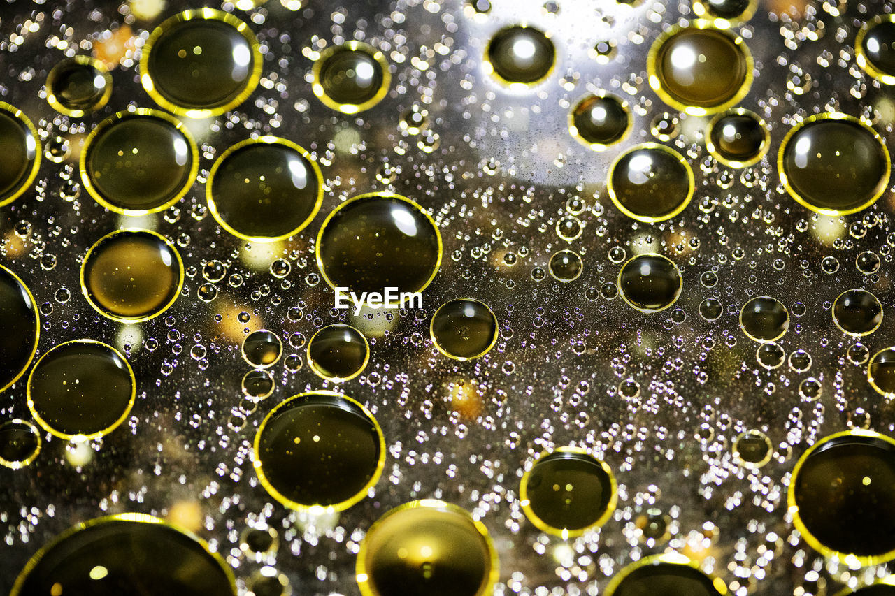 FULL FRAME SHOT OF WATER DROPS IN GLASS
