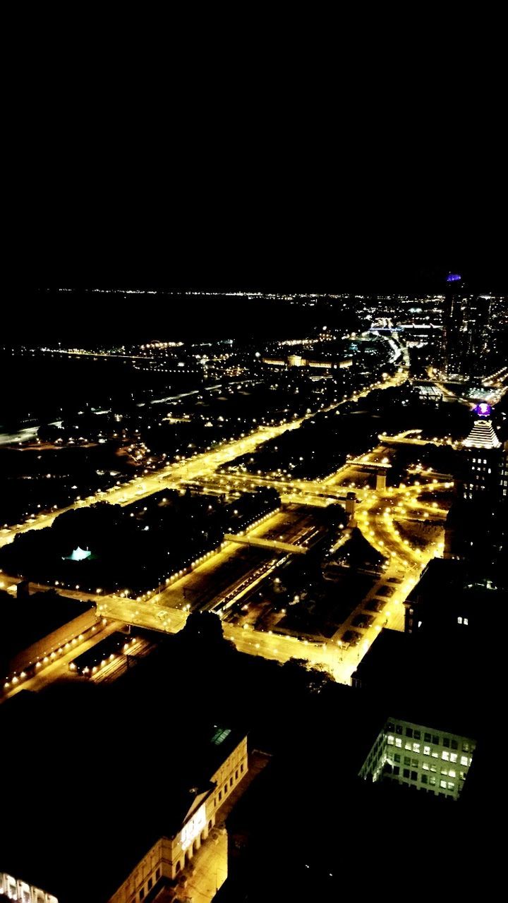 AERIAL VIEW OF ILLUMINATED CITYSCAPE AT NIGHT