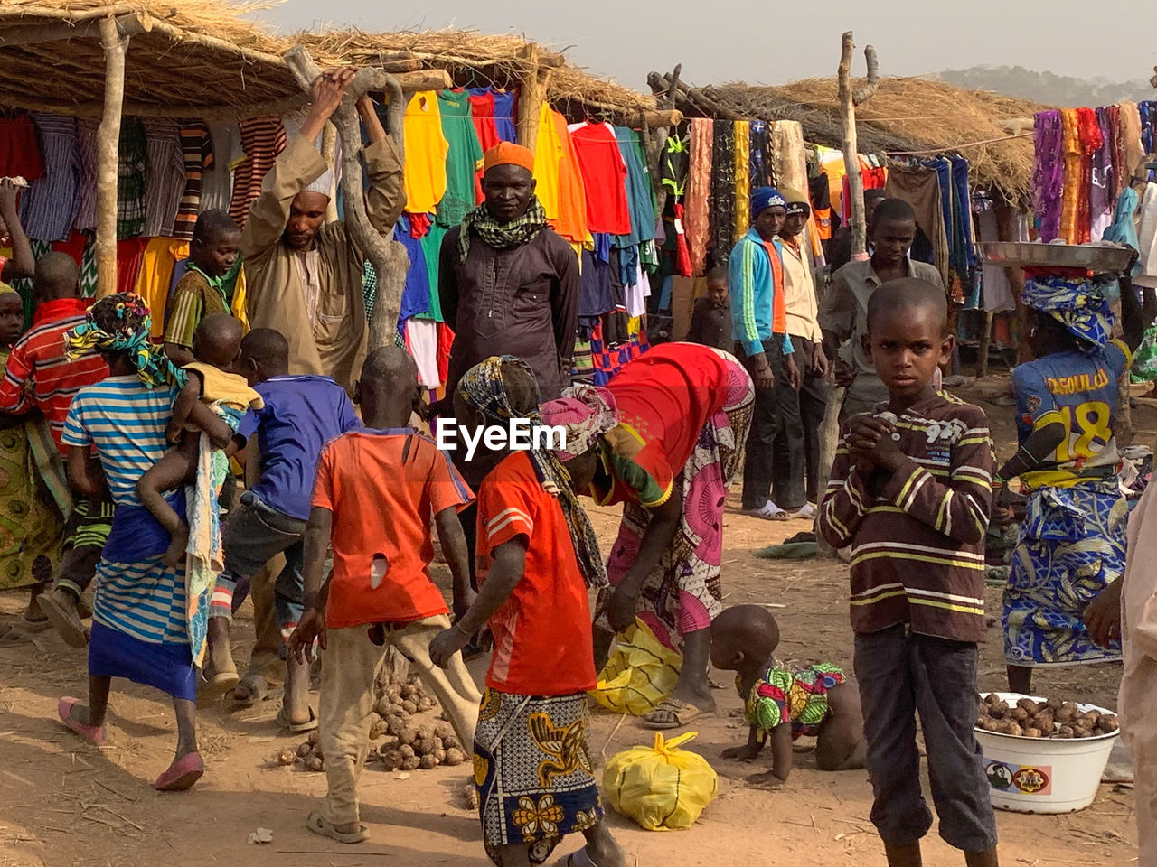 GROUP OF PEOPLE AT MARKET STALL