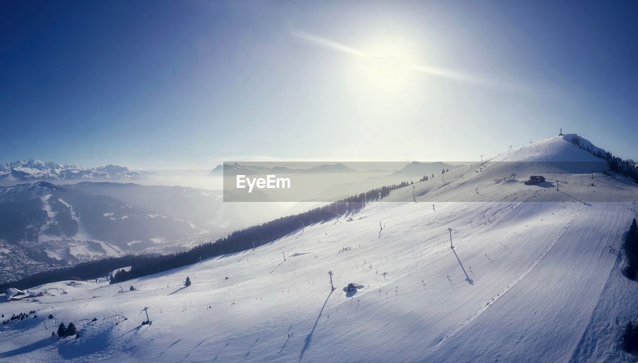 Scenic view of snow covered field against sky