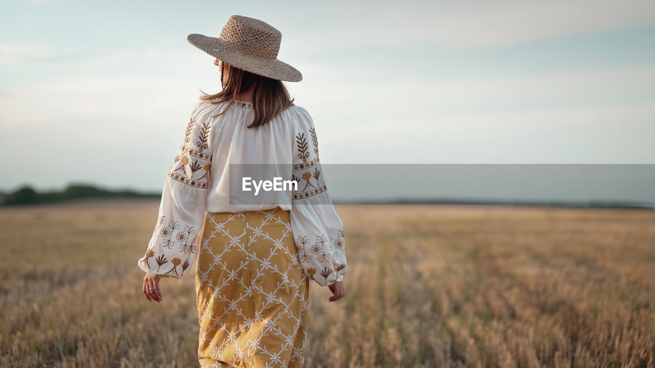 rear view of woman standing against sky