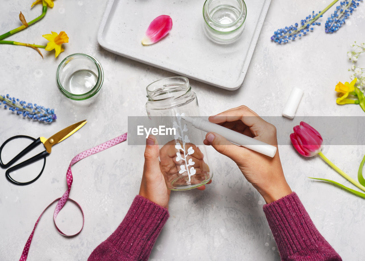 directly above shot of hand with pills and drink