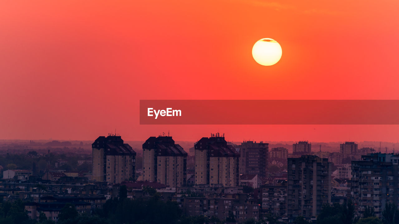 High angle view of buildings against sky during sunset