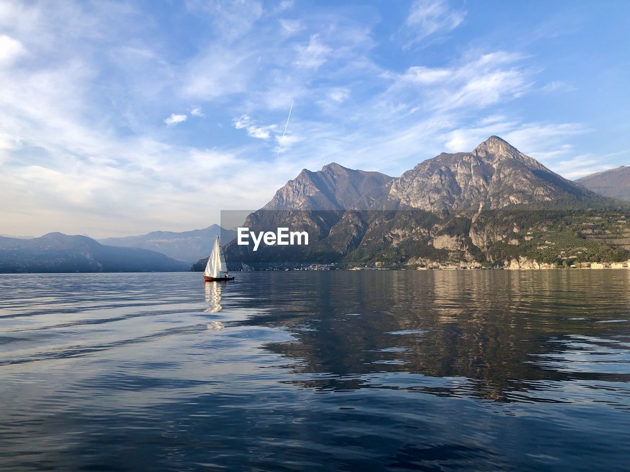 Scenic view of sea by mountains against sky lake of iseo