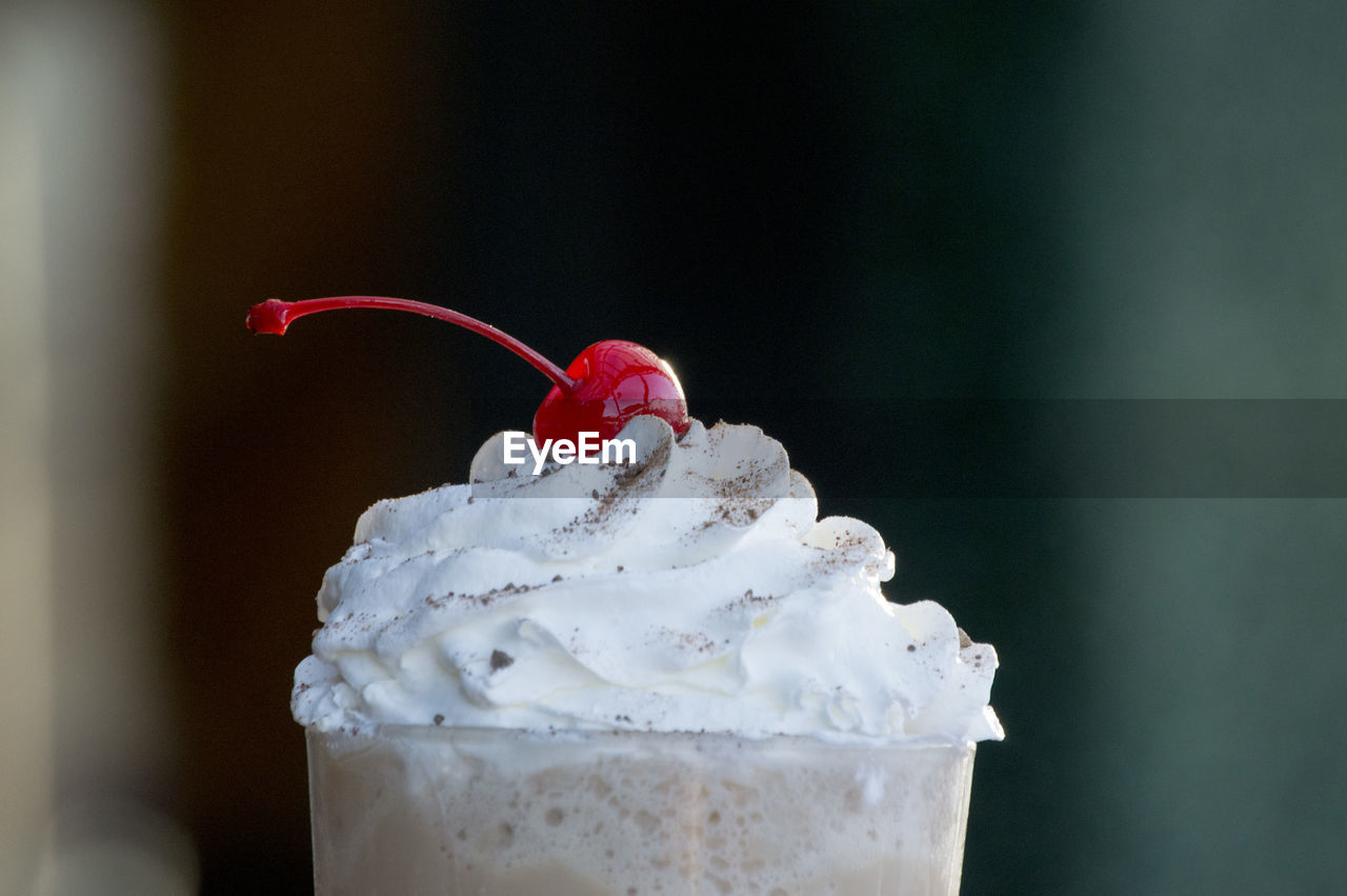 CLOSE-UP OF ICE CREAM CONE AGAINST WHITE BACKGROUND