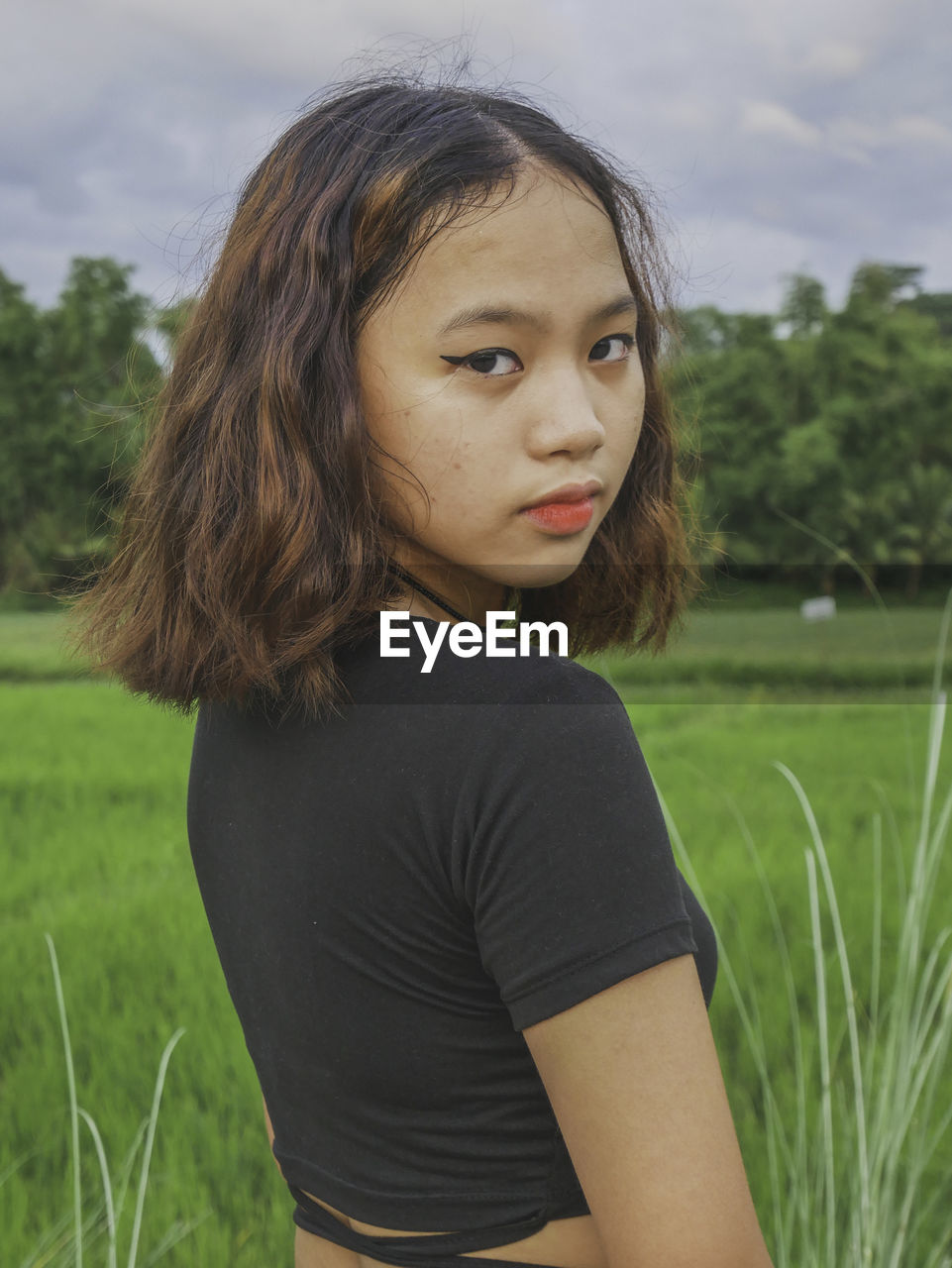 PORTRAIT OF TEENAGE GIRL ON GRASS