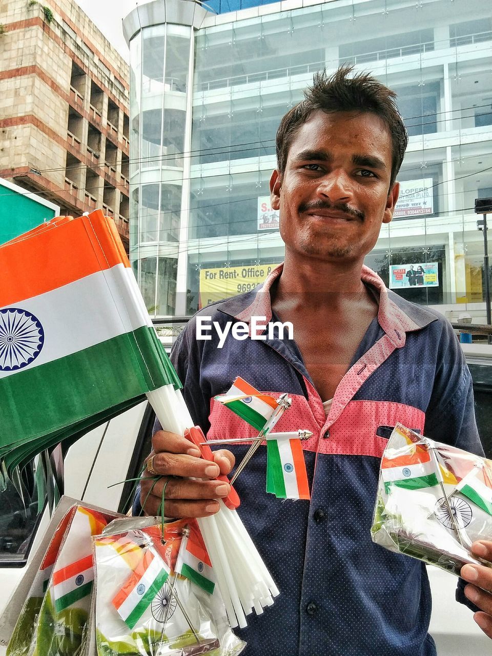 Portrait of male vendor selling indian flags in city