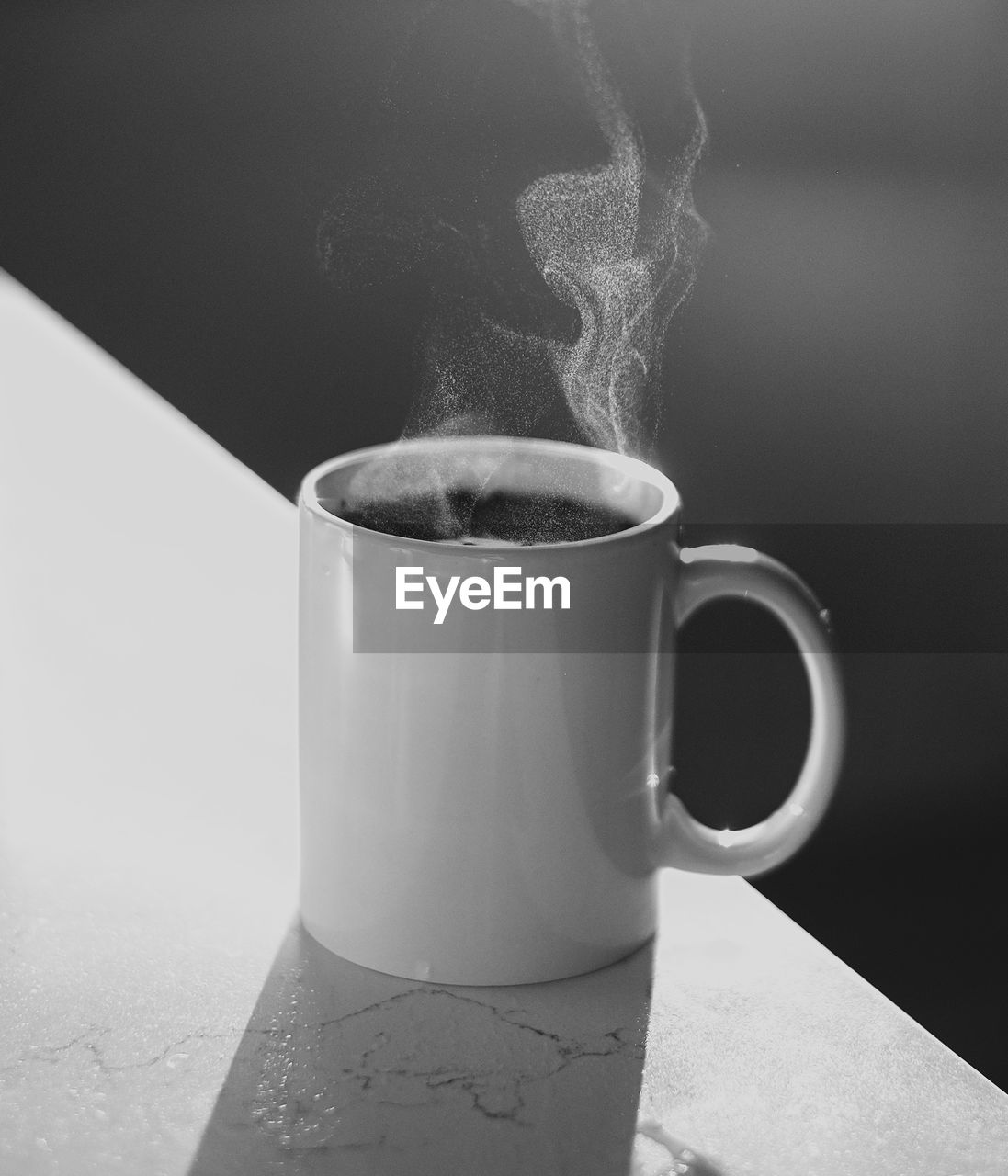 CLOSE-UP OF COFFEE CUP ON TABLE WITH SPOON