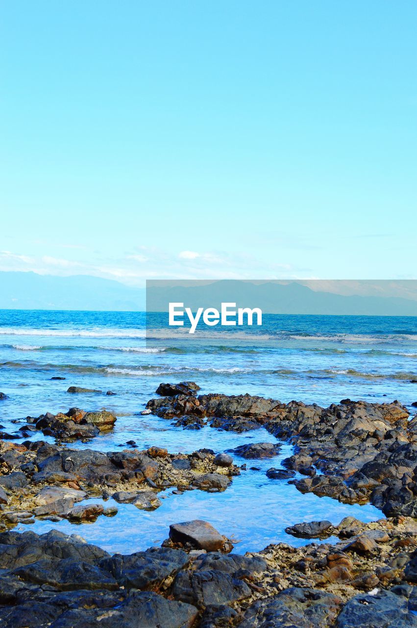 Scenic view of sea against blue sky