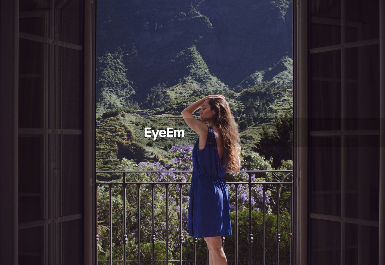 Woman standing on balcony