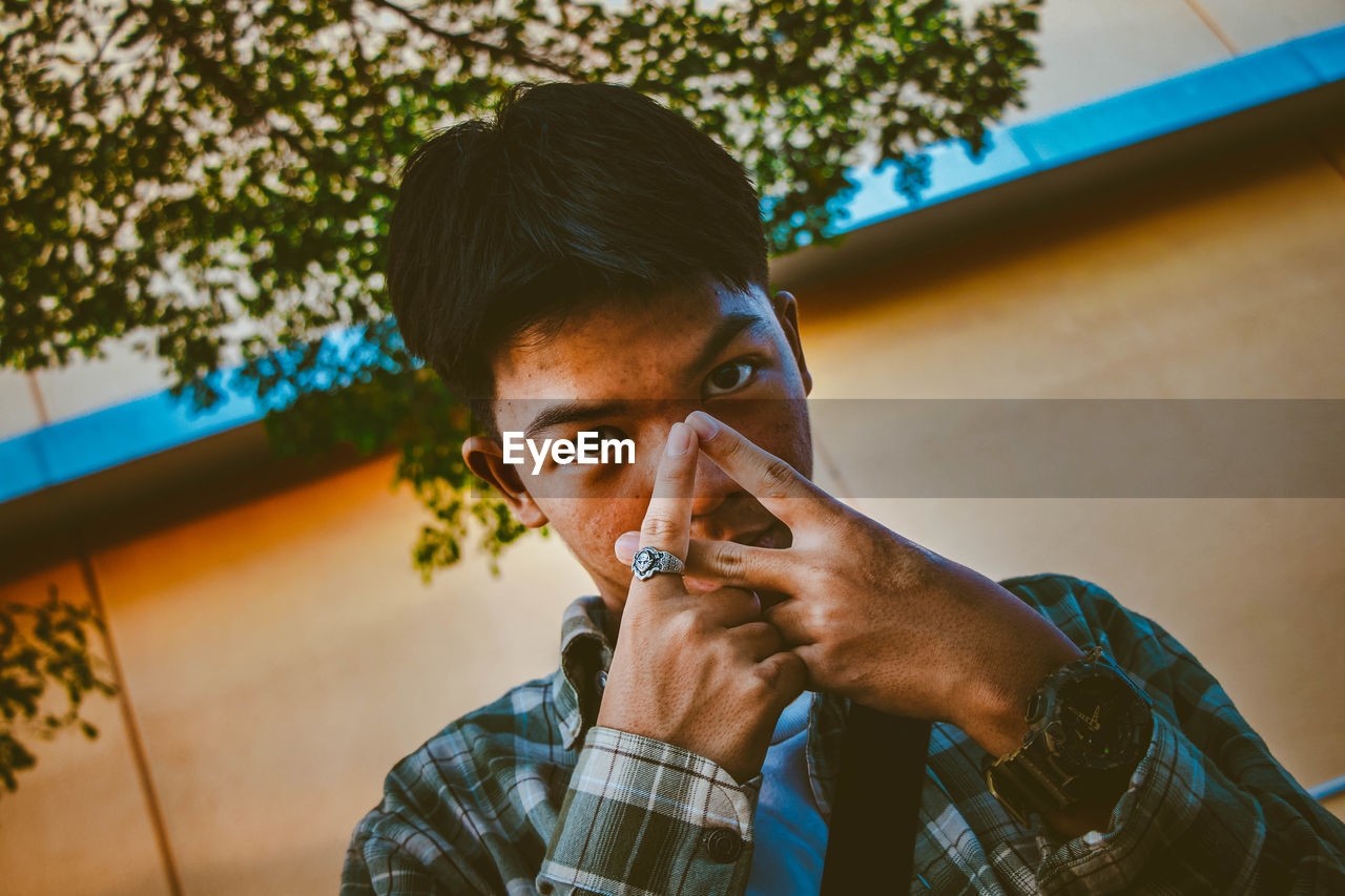 Close-up portrait of young man gesturing