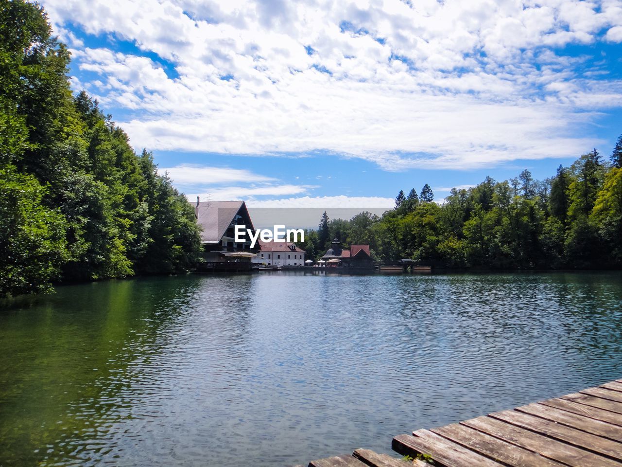 Scenic view of lake by buildings against sky