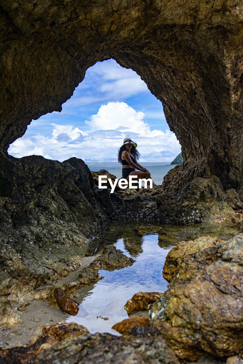 Woman sitting on rock