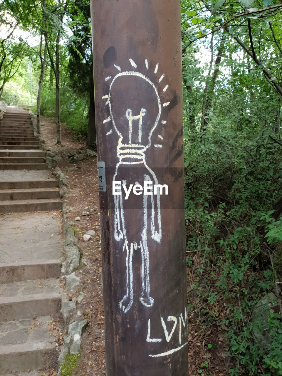 INFORMATION SIGN ON TREE TRUNK