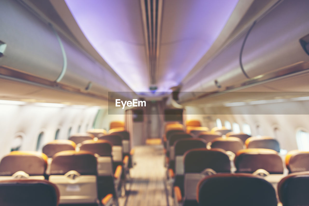 Burl background of an airplane cabin looking along the aisle