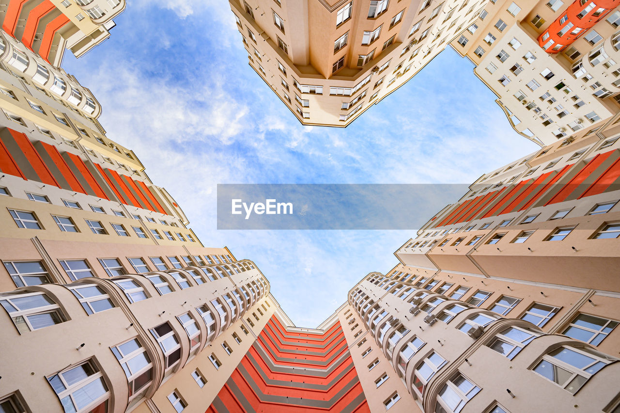 LOW ANGLE VIEW OF RESIDENTIAL BUILDINGS AGAINST SKY