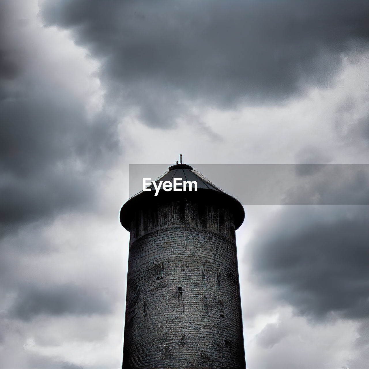 cloud, architecture, sky, built structure, building exterior, tower, guidance, lighthouse, nature, building, protection, low angle view, security, no people, storm, outdoors, overcast, black and white, monochrome, day, history, dramatic sky, the past, darkness, cloudscape, environment