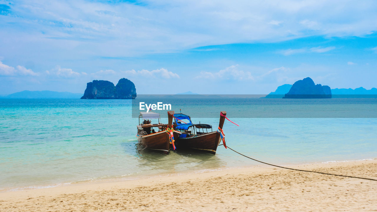 rear view of man on boat on sea against sky