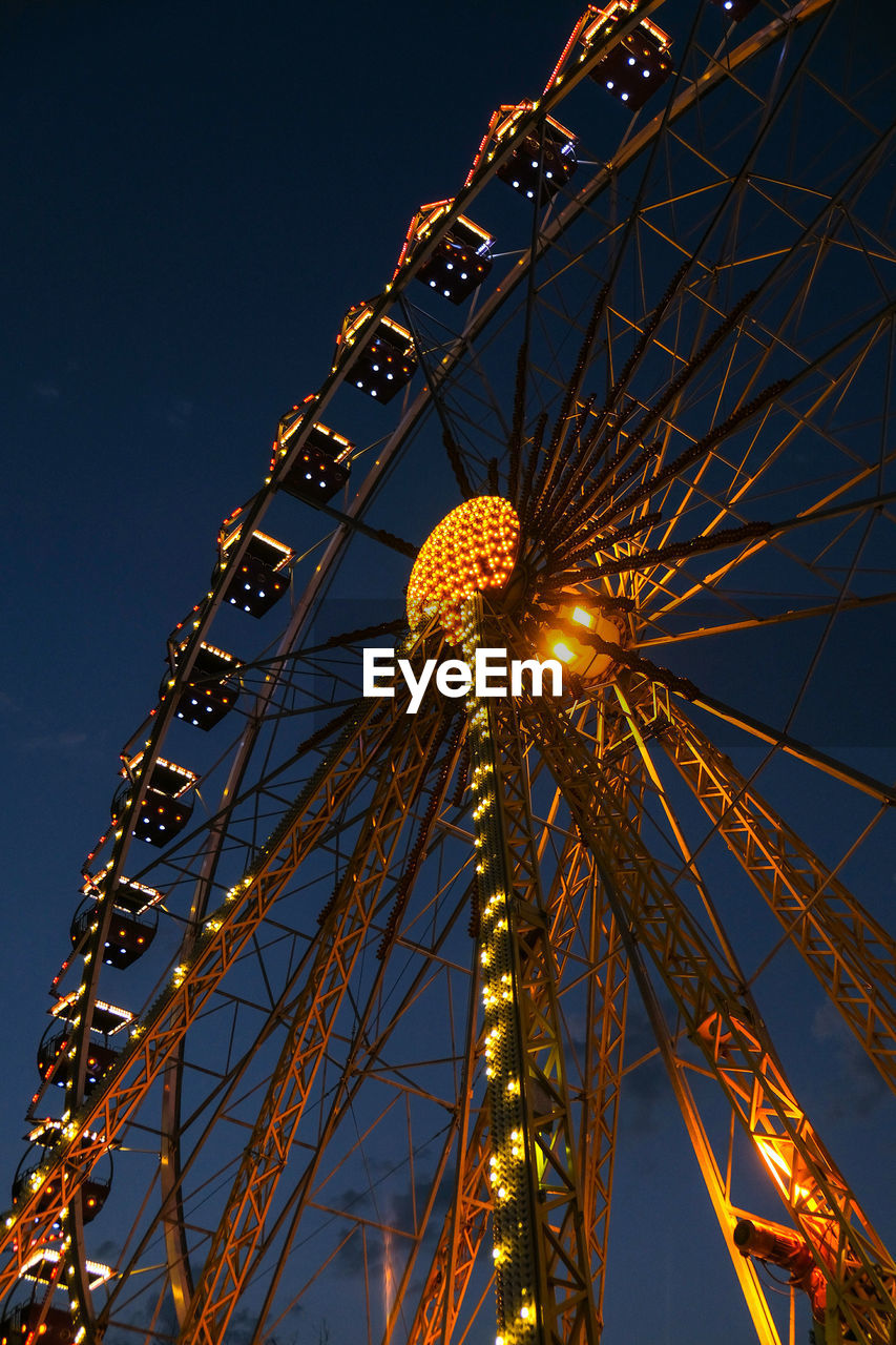 Ferris wheel lights at night. neon colored lights flashing on the ferris wheel. amusement park 