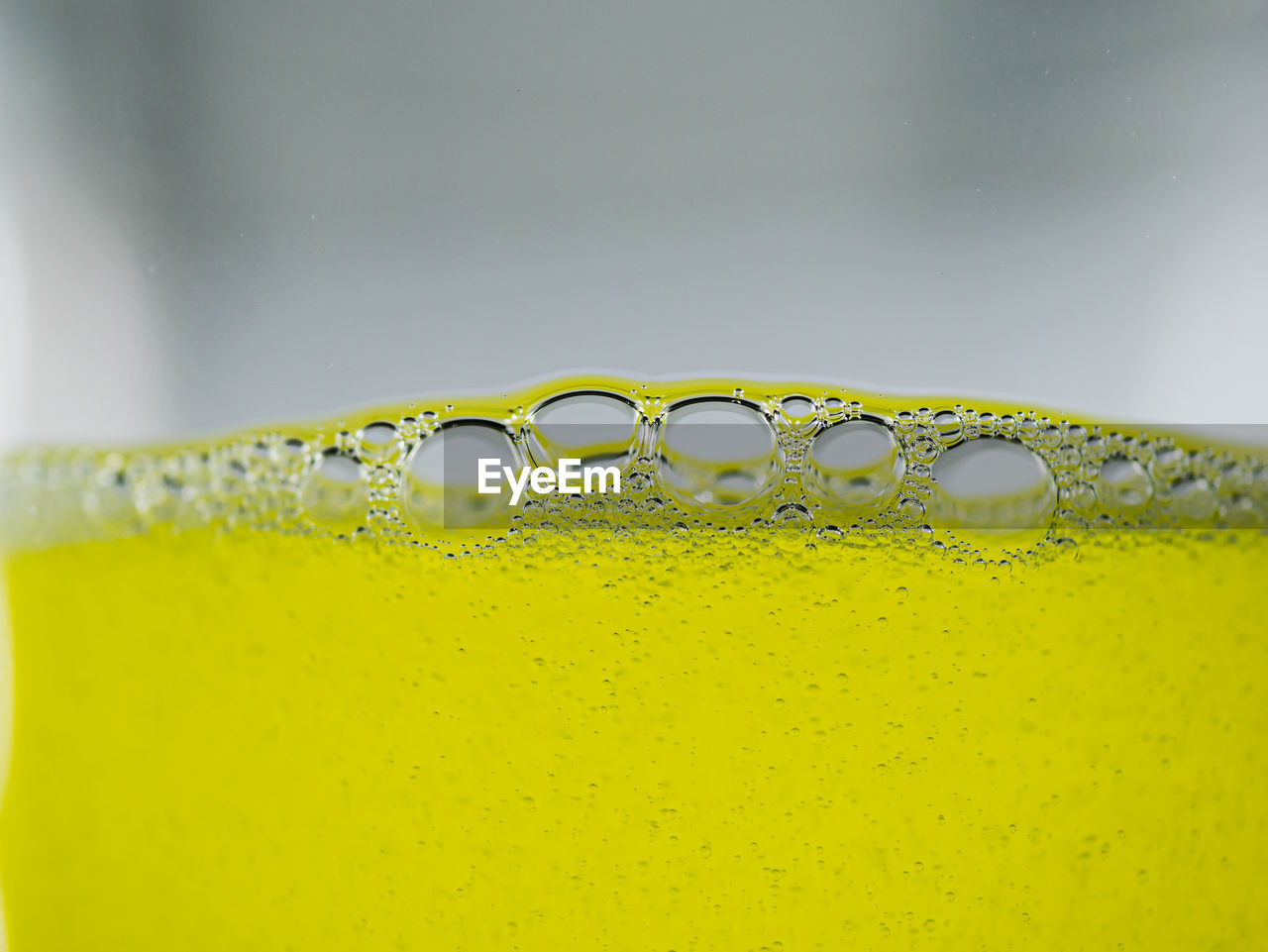 CLOSE-UP OF WATER DROPS ON GLASS OF YELLOW AND DRINK