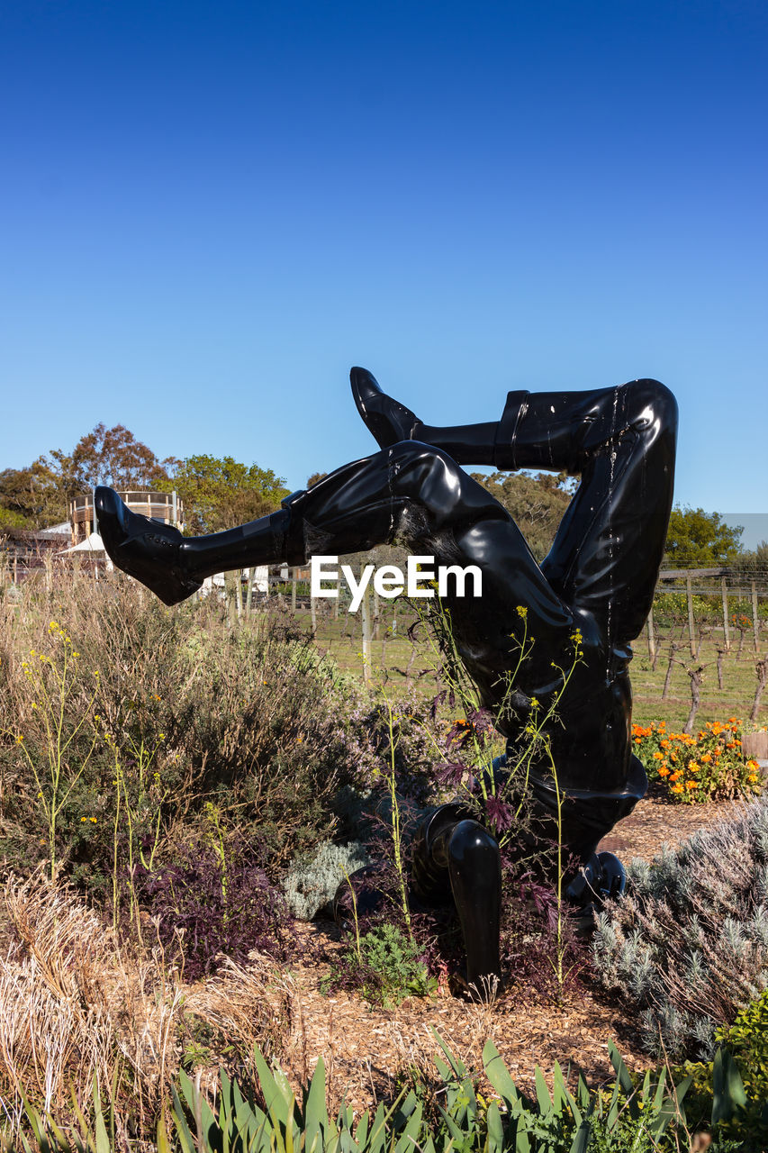 STATUE OF HORSE ON FIELD AGAINST CLEAR BLUE SKY