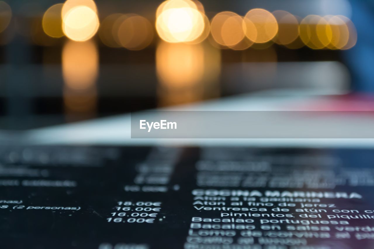 Close-up of illuminated text on table