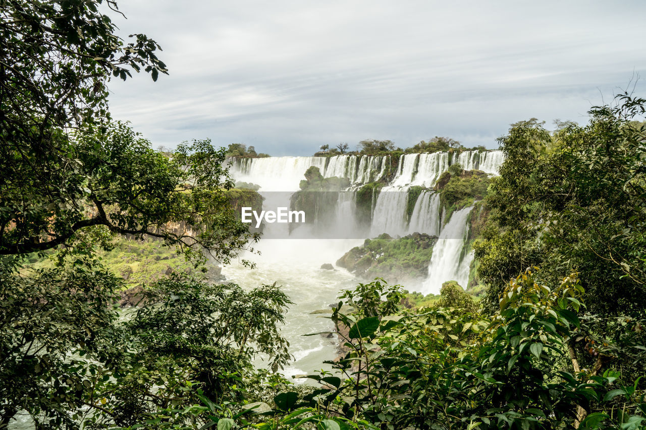 Scenic view of waterfall in iguazu against sky