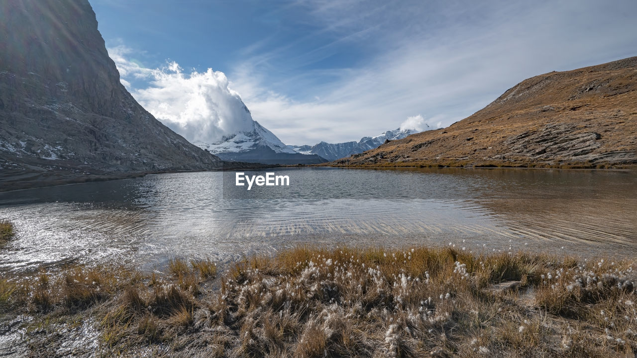 Scenic view of lake and mountains against sky