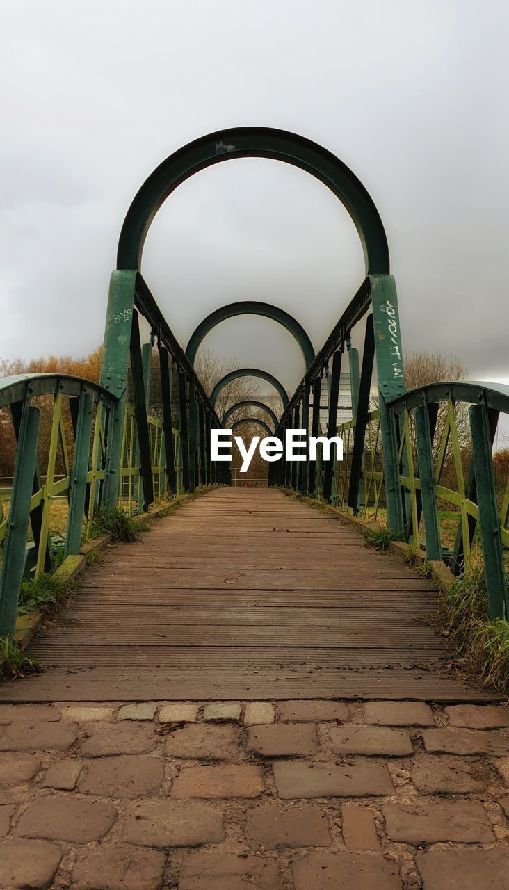 VIEW OF FOOTBRIDGE ALONG RAILINGS