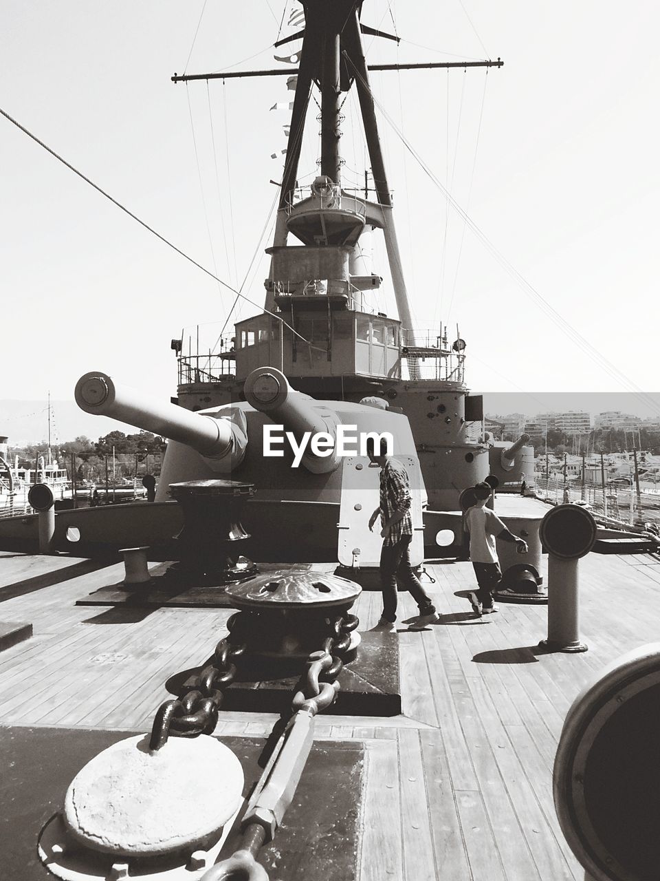 MAN AT HARBOR AGAINST SKY IN BACKGROUND