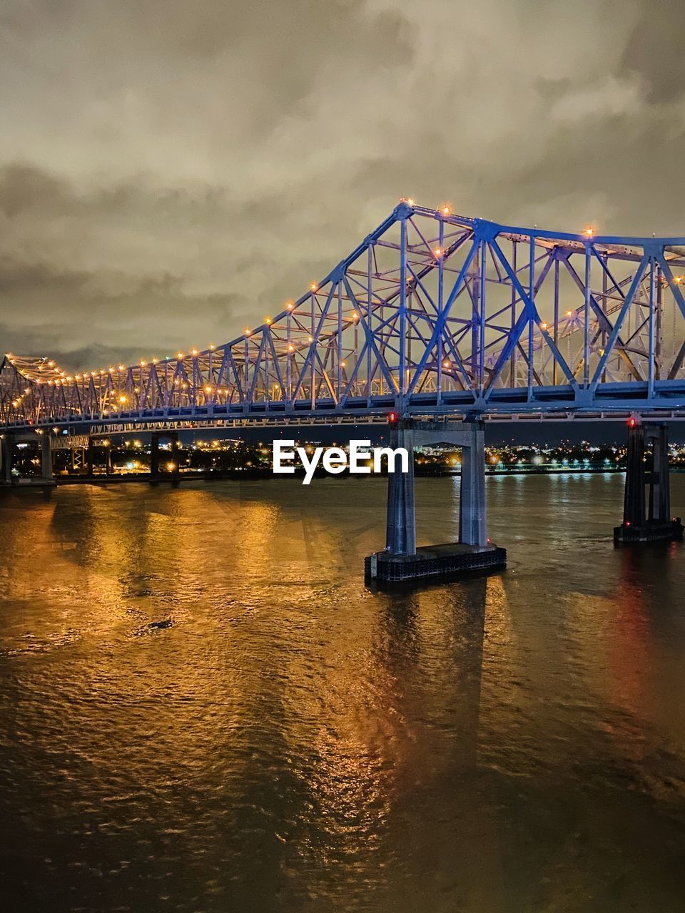 View of bridge over river against cloudy sky