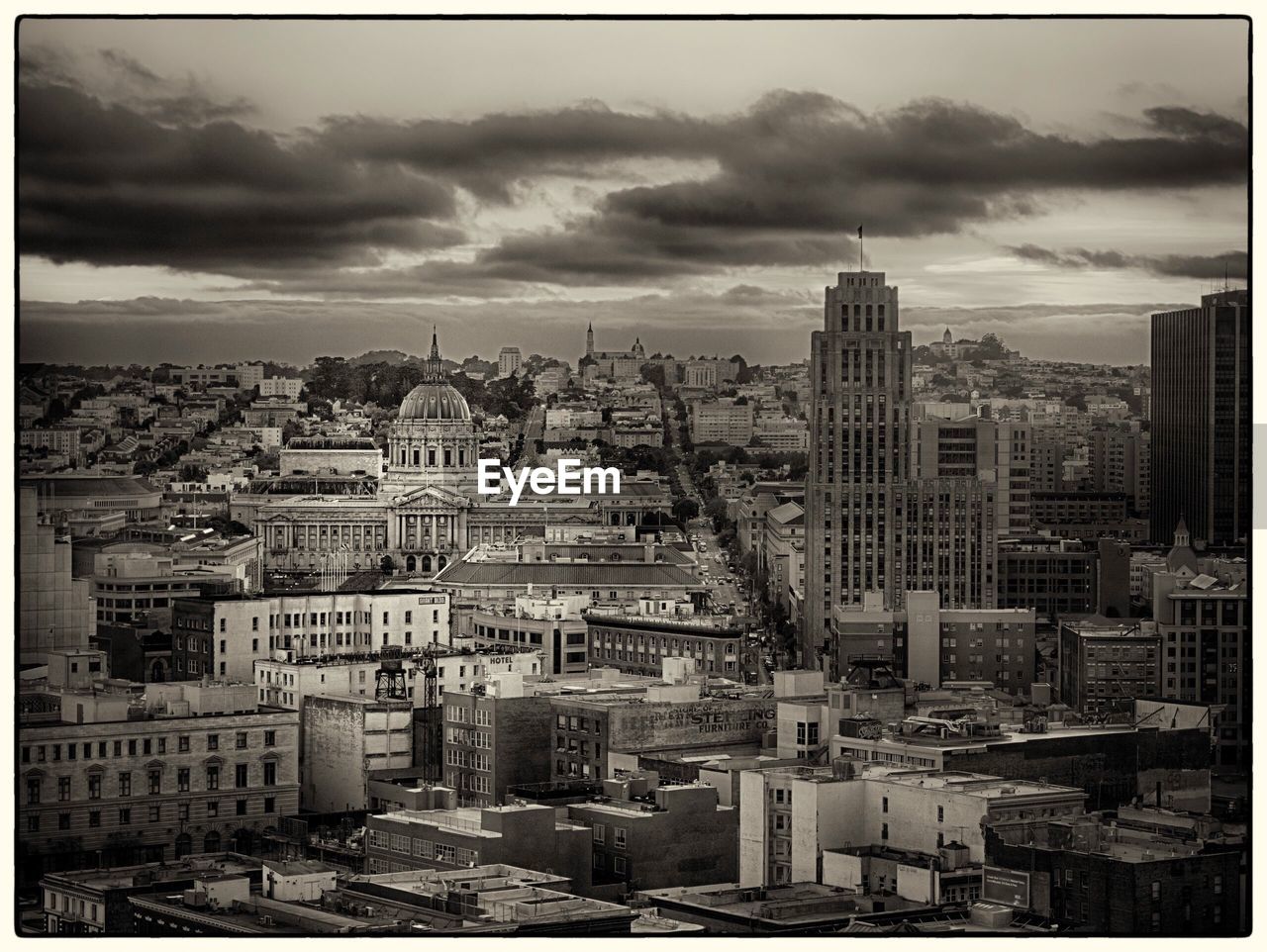 VIEW OF CITYSCAPE AGAINST CLOUDY SKY