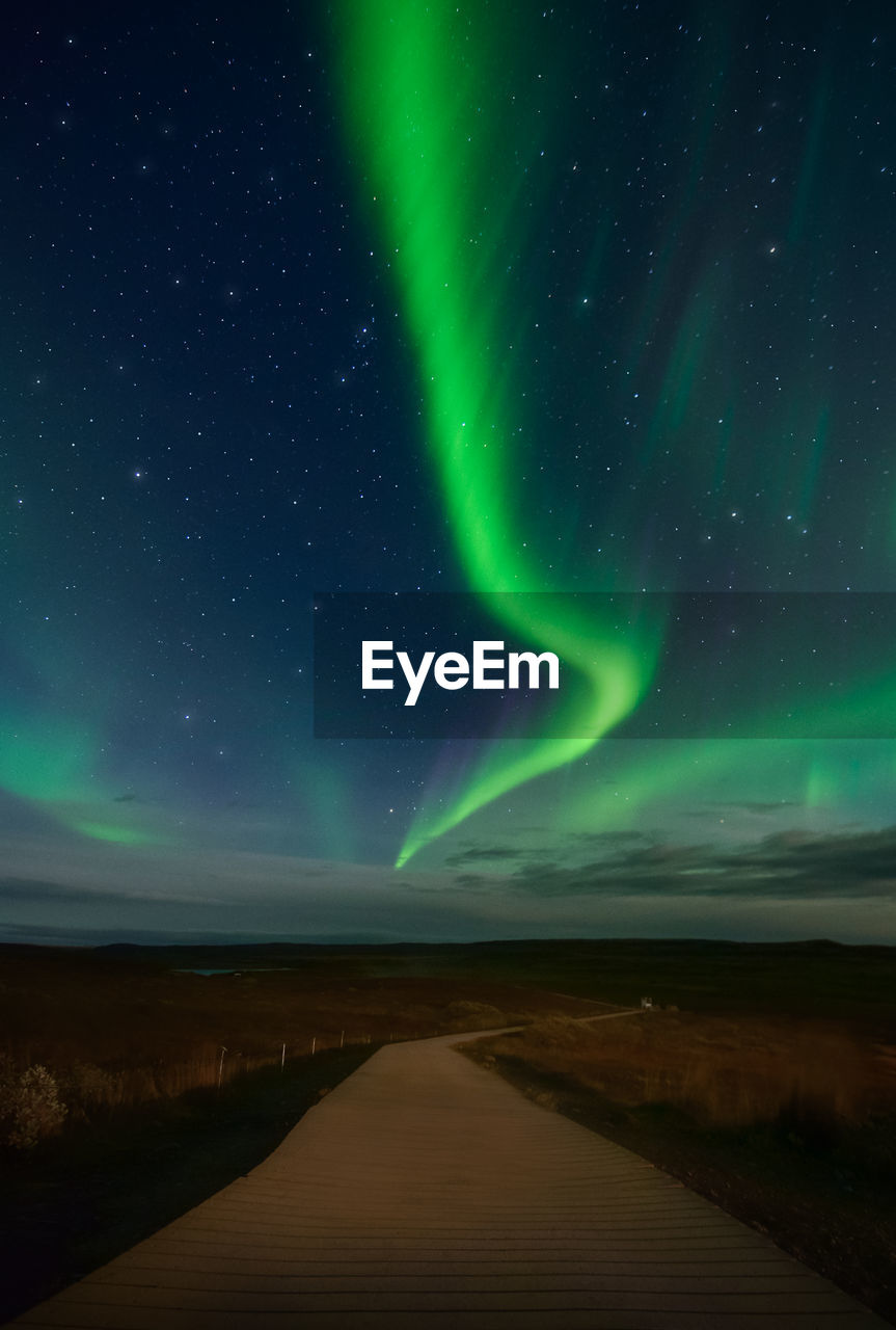 Scenic view of aurora borealis against sky at night