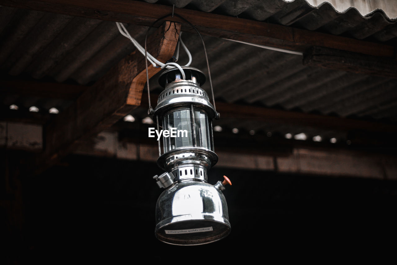 Low angle view of electric lamp hanging from ceiling