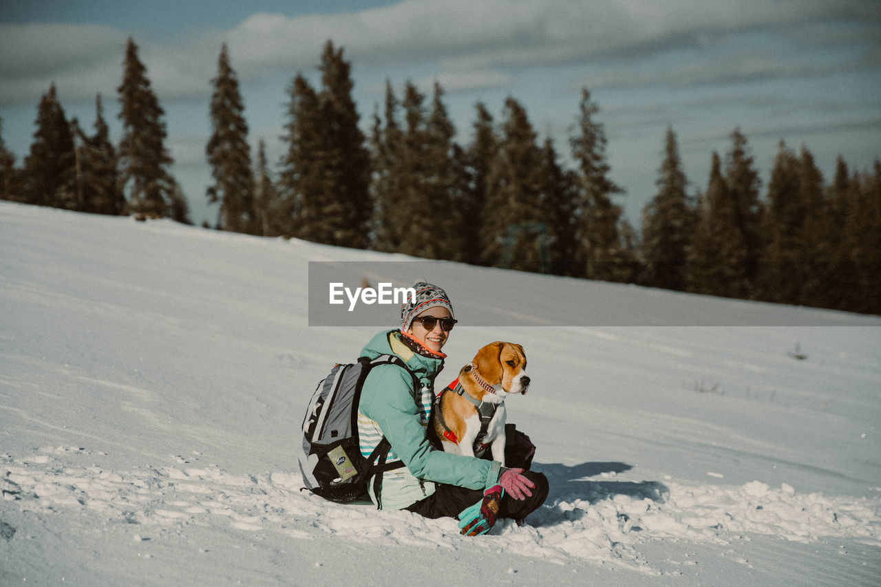 Girl playing with her dog on mountain