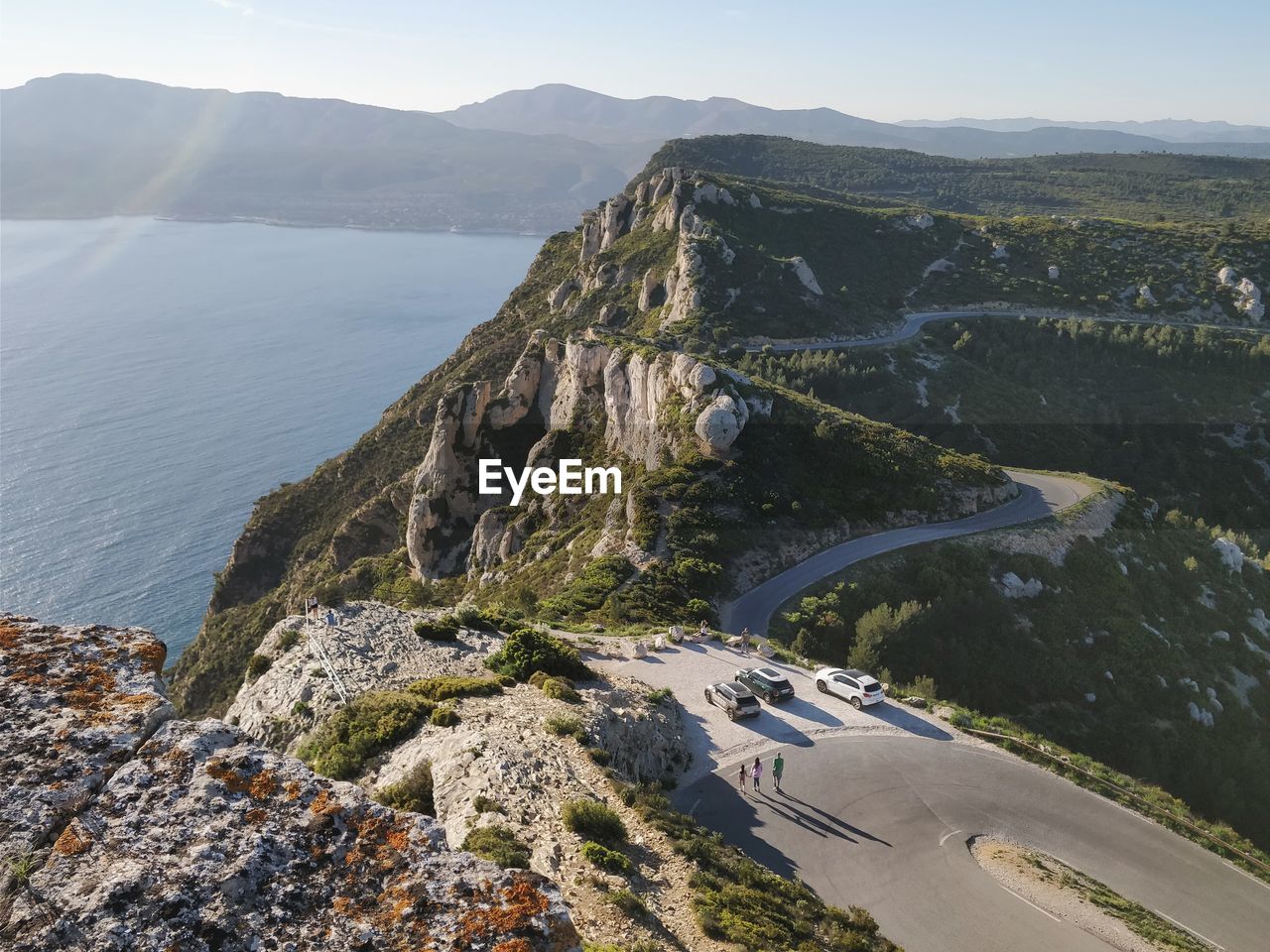 High angle view of sea by mountain against sky