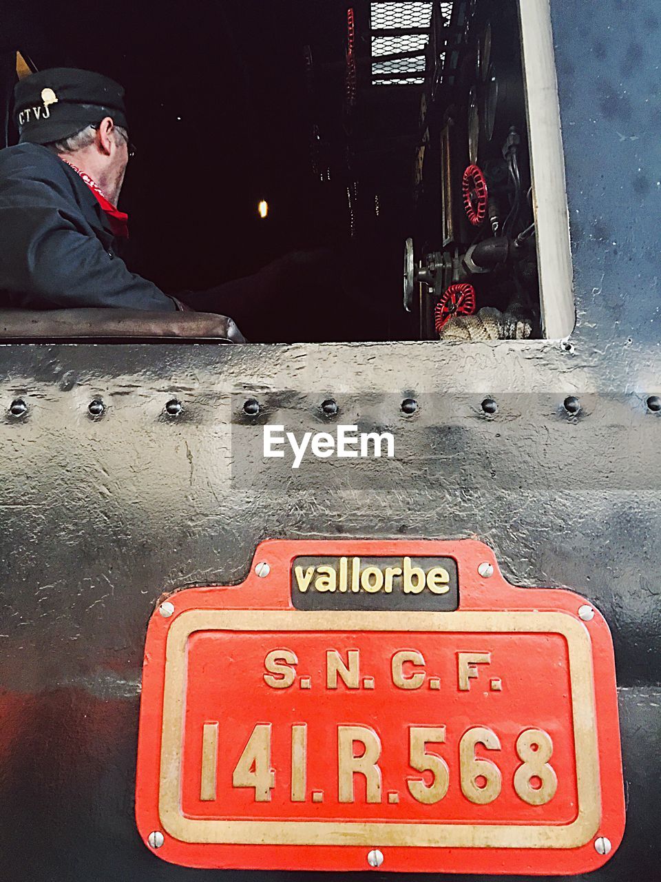 CLOSE-UP OF RED INFORMATION SIGN ON BUS