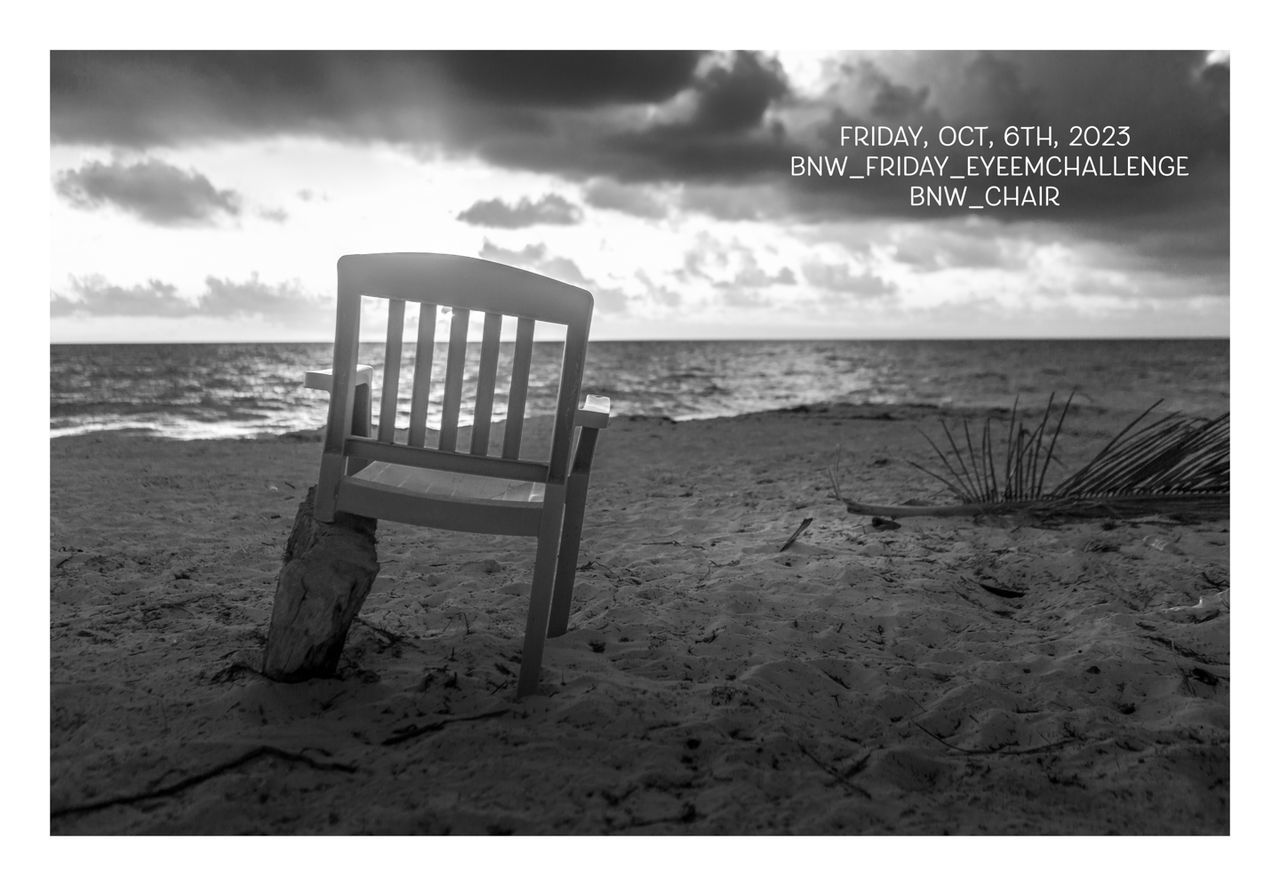 beach, black and white, land, sea, sky, nature, water, sand, cloud, horizon, auto post production filter, monochrome photography, horizon over water, chair, seat, empty, transfer print, tranquility, tranquil scene, no people, absence, scenics - nature, beauty in nature, day, furniture, outdoors, communication, relaxation