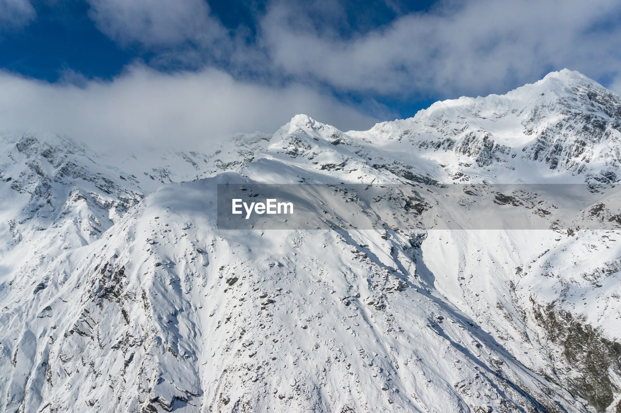 Scenic view of snow covered mountains against sky