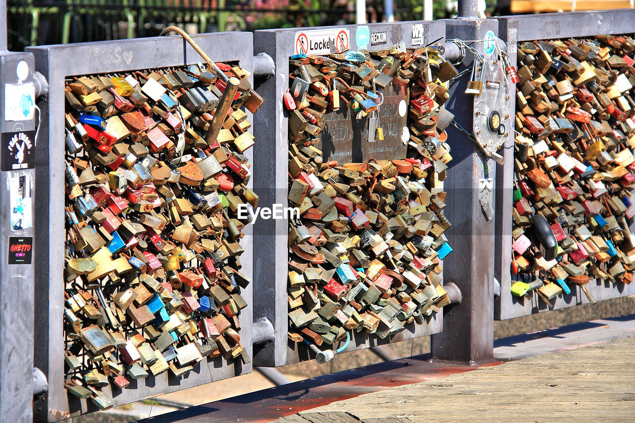 Love locks on railing at bridge in city