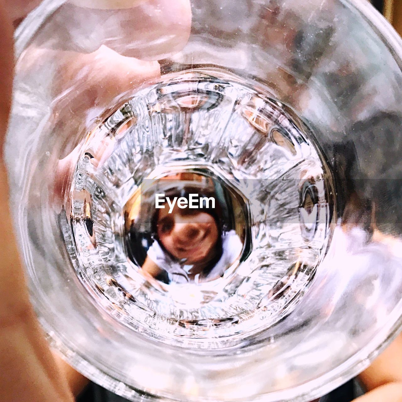 Close-up of woman looking through glass