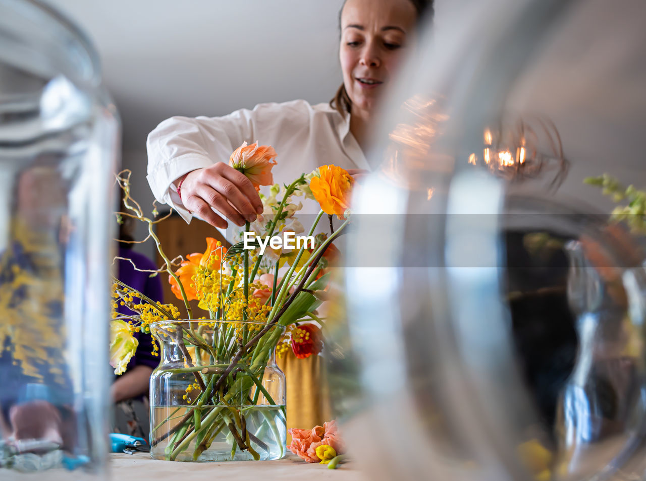 Florist girl makes a bouquet at am master class in flowers