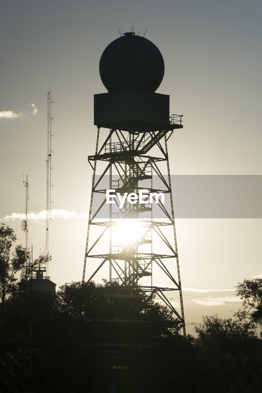 SILHOUETTE OF WATER TOWER AGAINST SKY