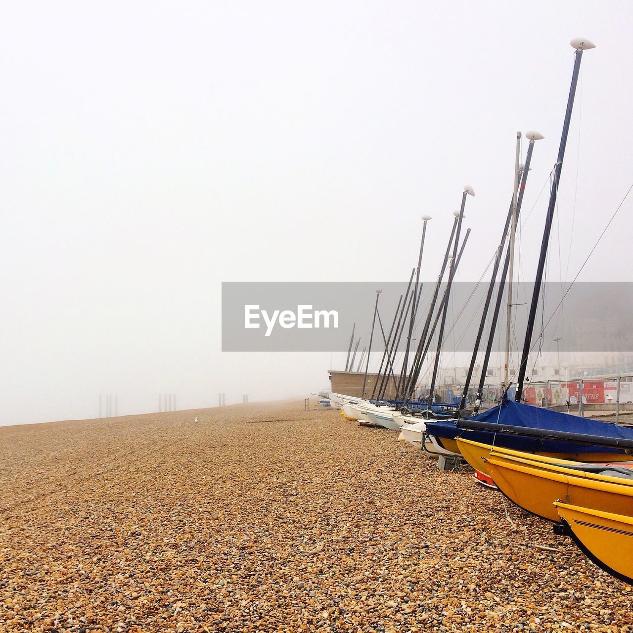 Boats on beach in fog