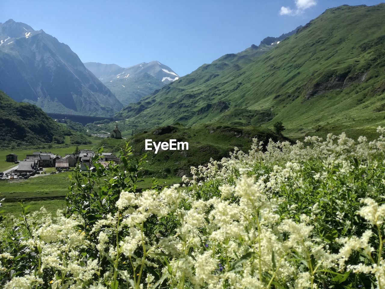 Scenic view of green landscape and mountains against sky