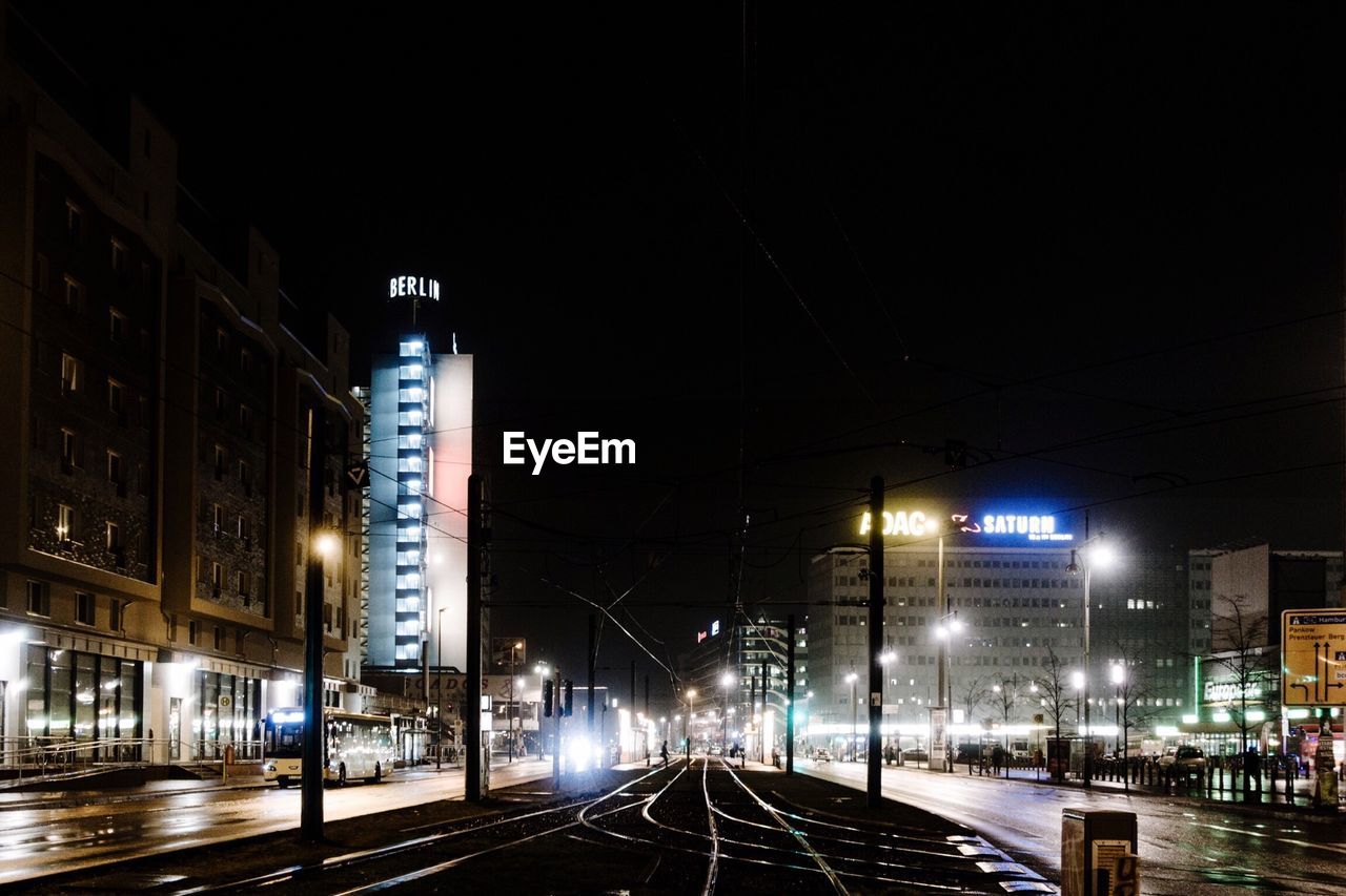 VIEW OF ILLUMINATED STREET AT NIGHT