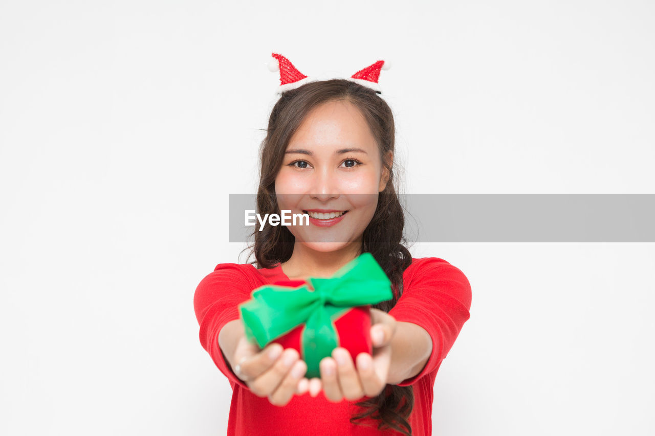 smiling, portrait, one person, happiness, red, studio shot, looking at camera, white background, emotion, celebration, women, christmas, cheerful, indoors, positive emotion, child, clothing, childhood, waist up, holiday, teeth, cute, smile, cut out, event, female, copy space, holding, front view, long hair, adult, fun, costume, pink, hairstyle, joy, brown hair, animal, heart shape, lifestyles, gift, valentine's day, person, dressing up